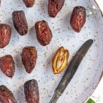 A plate full of dates and knives