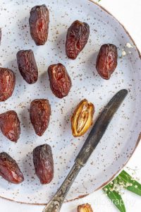 A plate full of dates and knives