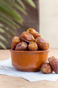 A food photograph of a bowl of dates